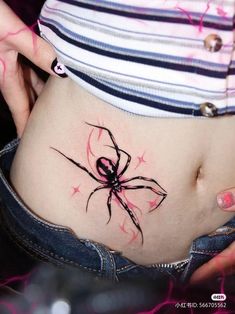 a woman's stomach with a spider tattoo on her belly and the bottom part of her abdomen