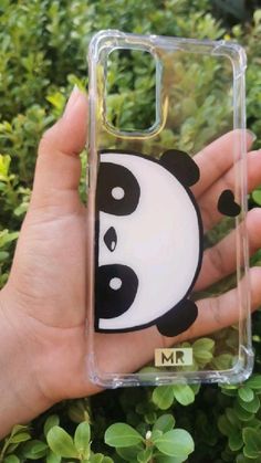 a hand holding up a case with a panda face on it