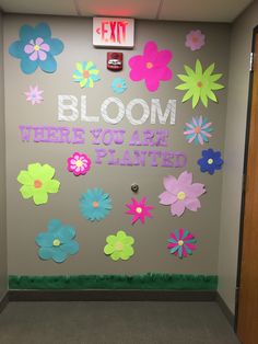 an office door decorated with flowers and the words bloom where you are planted