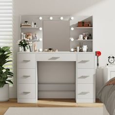 a white vanity with lights on it in a bedroom next to a potted plant