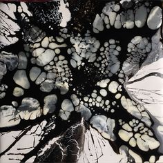 an abstract black and white painting with lots of small dots on it's surface