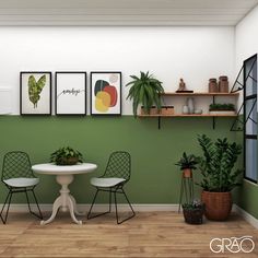 a green room with three chairs and a table in front of some potted plants