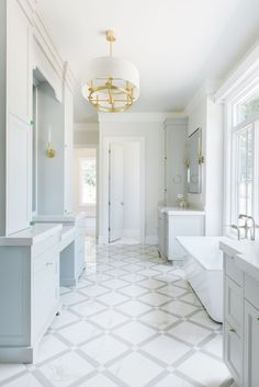 a white bathroom with a chandelier hanging from the ceiling