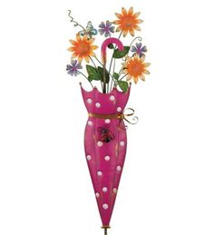 a pink umbrella shaped vase with flowers in it's bottom and an insect on the top