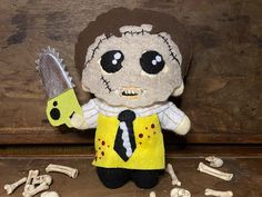 a stuffed animal with a tie and skull on it's head holding a knife