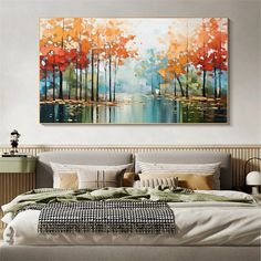 a large painting hanging above a bed in a bedroom