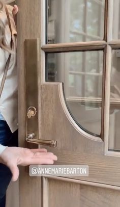 a woman is opening the door with her hand