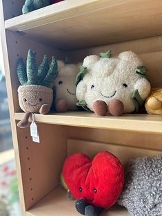 several stuffed animals are on shelves in a store