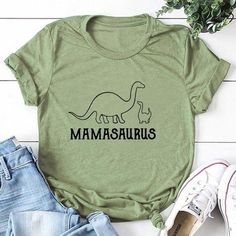 a t - shirt with the words mamasauruss on it next to jeans and shoes