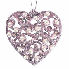 a heart shaped ornament with pearls on it