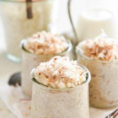 three small jars filled with oatmeal sitting on top of a table