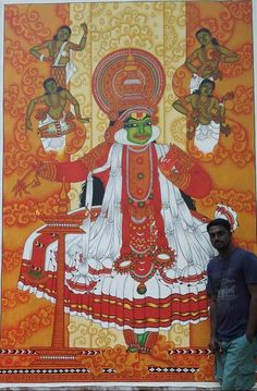 a man standing in front of a large painting