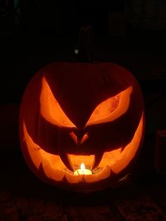 a carved pumpkin with an evil face on it