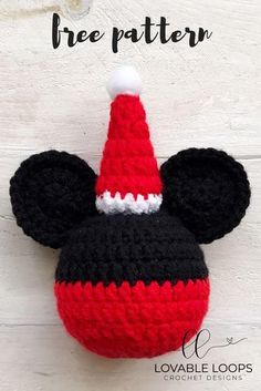 a crocheted mickey mouse hat hanging from the side of a white wooden wall