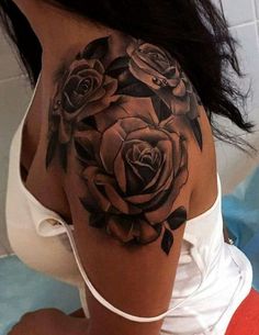 a woman with a black rose tattoo on her shoulder