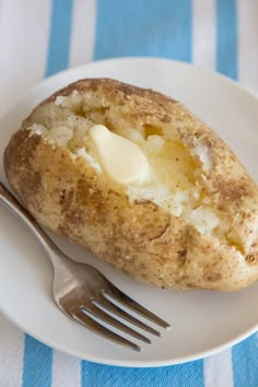 a white plate topped with a baked potato covered in butter