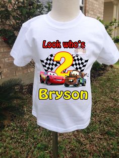 a white shirt with cars on it that says, look who's 2 bryson