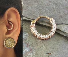 a close up of a person wearing earrings and a pair of hoop earrings