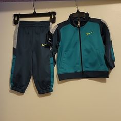 Nwt: Nike Boys 2 Piece Jacket And Pants Tracksuit Set Jacket: Front Full Zipper Closure Nike Swoosh On Left Chest 2 Front Functional Pockets Long Sleeves Pants: Elastic Waistband Nike Swoosh On Left Leg Elastic On Bottom Of Legs 100% Polyester Size: 12 Months Color: Squadron Blue Smoke Free And Pet Free Home Winter Sports Sets With Pockets, Fitted Blue Tracksuit With Pockets, Blue Fitted Tracksuit With Pockets, Nike Sets For Winter Playwear, Nike Long Sleeve Sets For Winter, Nike Long Sleeve Winter Sets, Blue Winter Playwear Sets, Blue Long Sleeve Sportswear Sets, Nike Long Sleeve Sports Sets