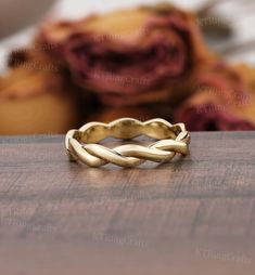 a gold ring sitting on top of a wooden table