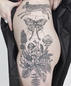 a woman's thigh with an insect tattoo on it