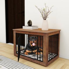 a black and brown dog sitting in a crate on the floor next to a rug