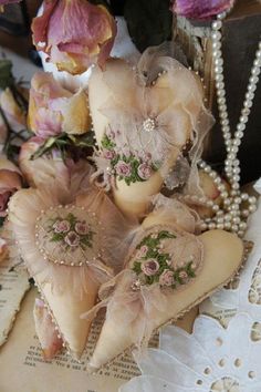 some flowers and pearls are on top of an old book