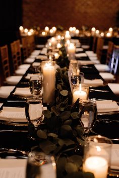 a long table is set with candles and place settings