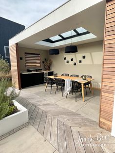 an outdoor dining area with wooden tables and chairs