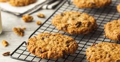 cookies cooling on a wire rack next to a glass of milk