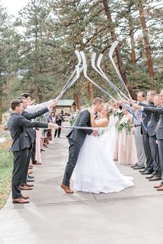 a bride and groom are holding their wedding balloons