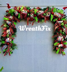 a wreath with the words wreathfix written on it and decorated with christmas decorations