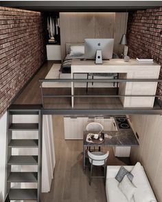 an aerial view of a living room and kitchen area with stairs leading up to the loft