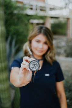 a woman is holding a compass in her hand