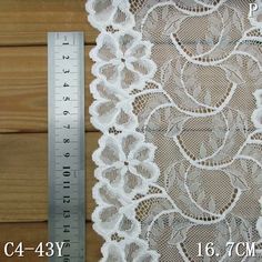 a ruler is next to a white lace