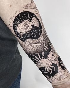 a person with a black and white tattoo on their arm