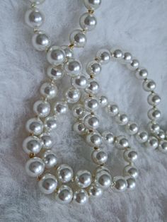 For Sale: Vintage Shining white faux pearl necklace. 🦪 The faux pearls have a beautiful silver glow.  Perfect condition. The slide lock closure is made of silver plated sunburst design with a pearl middle.  A couple of discolored spots are on the back of the silver plated closure.🦪 The pearls  are 8mm.   Two strands - 24" and 22"  - extra long pearl necklace  The knot spacers between each pearl are perfect - I see no indication that this pearl necklace has been altered from its original condition. 🦪 All are original.  A very pretty pearl necklace in beautiful vintage condition! Questions?🦪 "God changes caterpillars into butterflies, sand into pearls and coal into diamonds using time and pressure. He can change a sad heart into joy." Vintage Pearl Necklace, Long Pearl Necklace, Pearl Necklace Vintage, Beads For Sale, Slide Lock, Long Pearl Necklaces, Faux Pearl Necklace, Vintage Pearls, Chain Styles