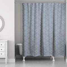 a bathroom with a sink, mirror and shower curtain in grey color on the wall