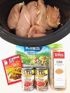 the contents of a slow cooker including chicken, spices and seasoning are shown