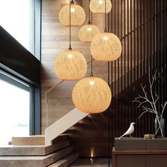 a bunch of lights hanging from the side of a stair case next to a window