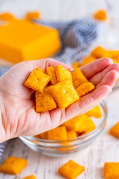 a person is holding some kind of cracker in their hand and it's on the table