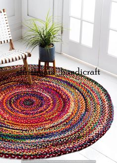 a multicolored rug with a chair and potted plant