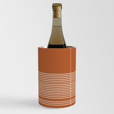 a bottle of wine in an orange canister with a cork top on a white background