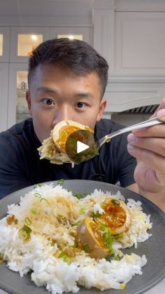 a man eating food from a plate with chopsticks