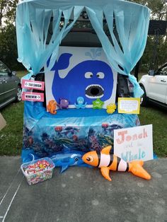 an under the sea themed birthday party with toys and decorations on display in front of a tent