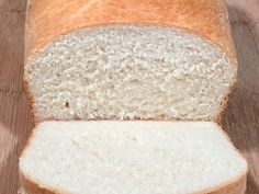 a loaf of white bread sitting on top of a wooden table