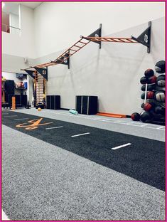 an indoor basketball court with equipment on the floor