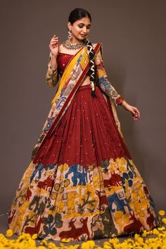 Maroon base attached cancan lehenga with elephant and deer kalamkari hand painted patterns and embroidery. Paired with padded peach blouse embroidered with glass beads and yellow printed dupatta with contrast lace border. - Aza Fashions Unstitched Anarkali Set With Kalamkari Print For Wedding, Kalamkari Print Anarkali Set For Wedding, Anarkali Style Wedding Palazzo Set With Kalamkari Print, Anarkali Style Kalamkari Print Palazzo Set For Wedding, Floor-length Kalamkari Anarkali Set For Wedding, Multicolor Art Silk Palazzo Set For Wedding, Wedding Palazzo Set With Kalamkari Print For Diwali, Red Kalamkari Print Choli For Wedding, Red Kalamkari Print Lehenga For Festivals