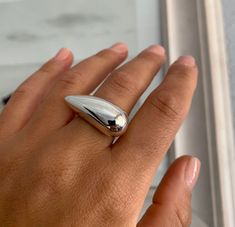 "Long Statement Ring, Chunky Dome Ring, Modern Silver Ring, Sterling Silver, Teardrops Ring, Geometric Ring, Minimalist Ring, Ring for Women Βeautiful minimalist geometric design tear shape ring with polished finish. It is a perfect gift for yourself or for someone that you care for ✔~ 100% Handmade ~ ✔~ 100% 925 Sterling Silver ~ ✔~ Height 12.0 MM ~ \"the upper part\" ~ ✔~ Width 13.0 MM ~ \"the upper part\" ~ ✔~ Length 32.0 MM ~ \"the upper part\" ~ ✔~ Weight 10.0 grams \"in medium size\" ~ ✔~ Modern Silver Ring, Big Statement Rings, Minimalist Silver Ring, Artsy Jewelry, Jewelry Product Shots, Silver Casting, Modernist Ring, Teardrop Ring, Dome Ring