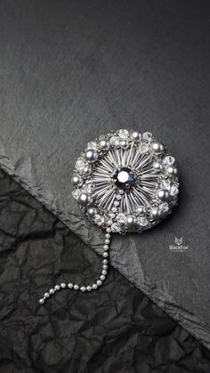 Beautiful handmade brooch in the shape of a dandelion. It is embroidered with a Swarovski crystal, pearls and faceted beads. #beadedbrooch #crystalbrooch #silverbrooch #handmadebrooch #broochpin Elegant Silver Beaded Brooches, Silver Embellished Wedding Brooches, Silver Embellished Brooches For Gift, Beads Brooch, A Dandelion, Crystal Brooch, Brooches Handmade, Beaded Brooch, Silver Brooch